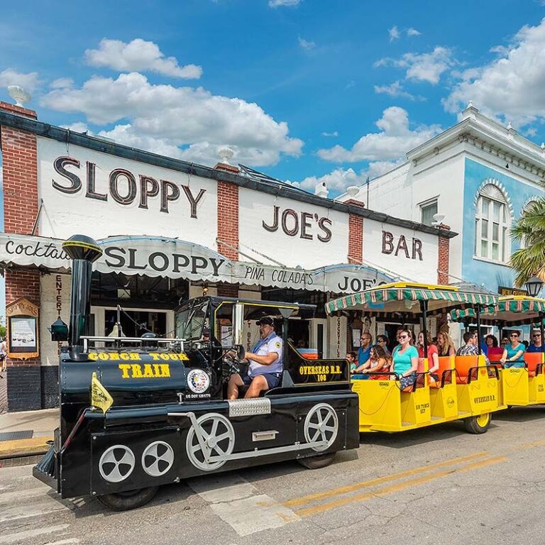 Conch Tour Train driving by Sloppy Joes Bar