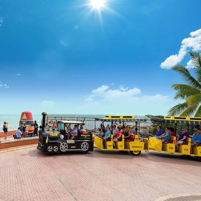 Conch Tour Train driving by Southermost Point