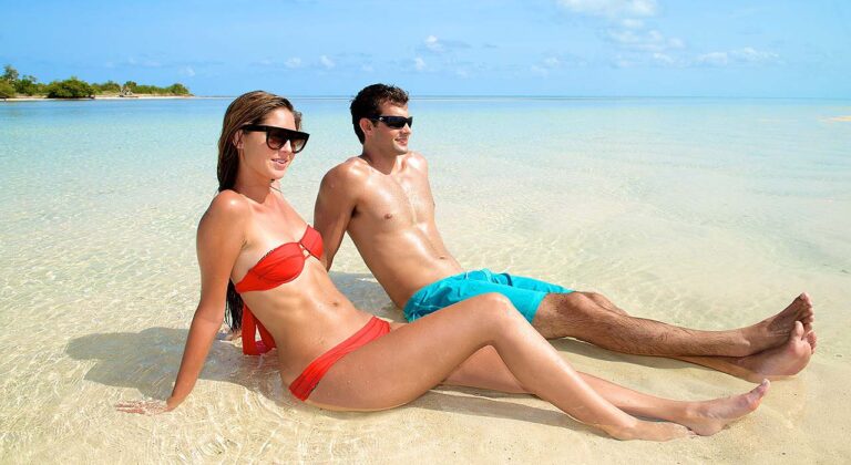 couple sitting on a sandbar in Key West