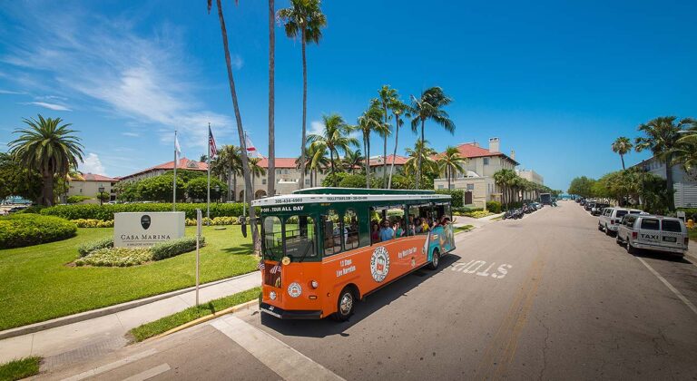 Old Town Trolley driving past Casa Marina in Key West