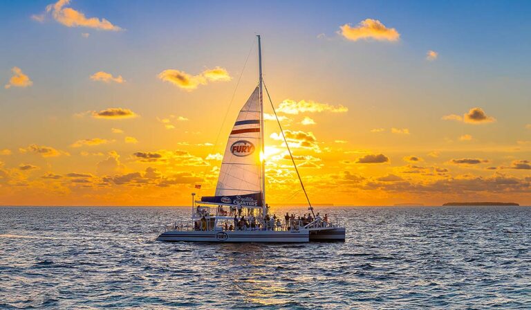 fury catamaran sailing at sunset